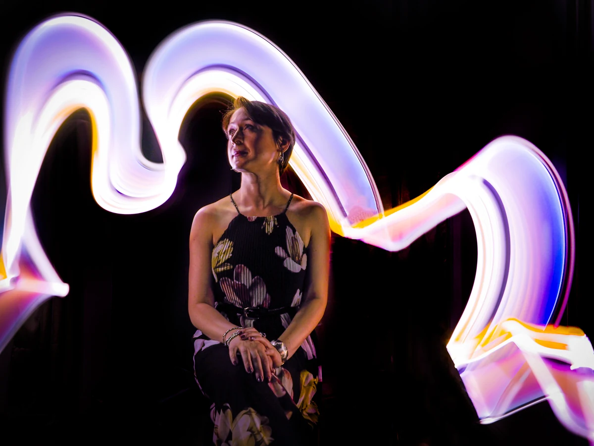 Light Painting portrait with a white and violet light ribbon