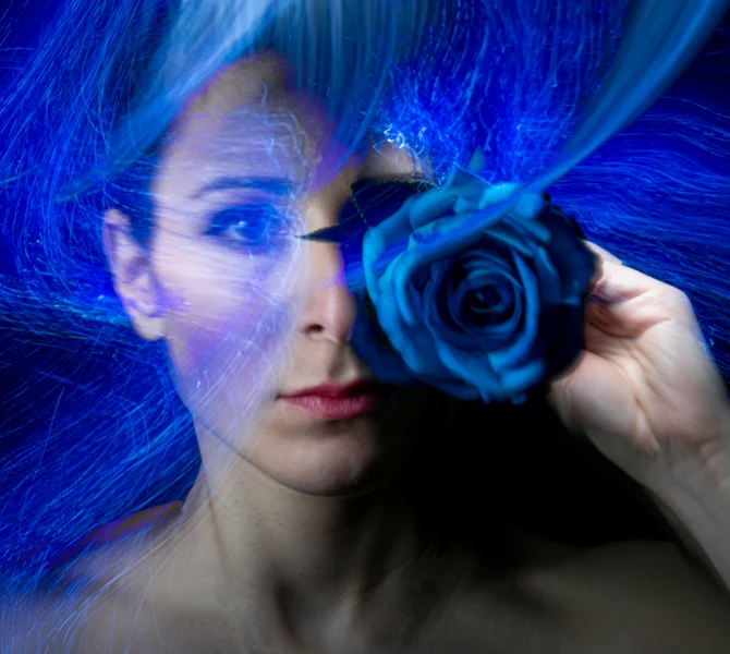 Portrait of Maria Saggese, with a blue rose and light trails